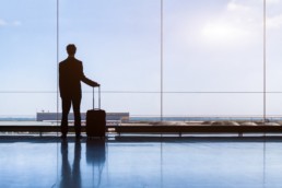 Traveler businessman in airport lounge waiting for flight, standing © NicoElNino / Fotolia