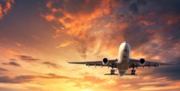 Landing airplane. Landscape with white passenger airplane is flying in the blue sky with clouds at colorful sunset. Travel background. Passenger airliner. Business trip. Commercial aircraft. Concept © den-belitsky / Fotolia